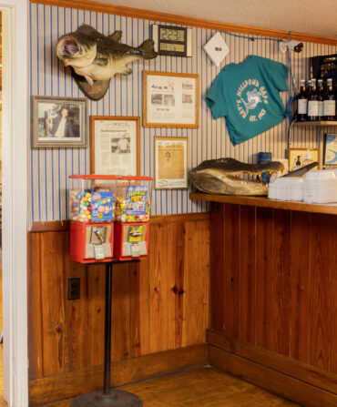 A gumball machine and knick knacks on the wall of a restaurant entrance