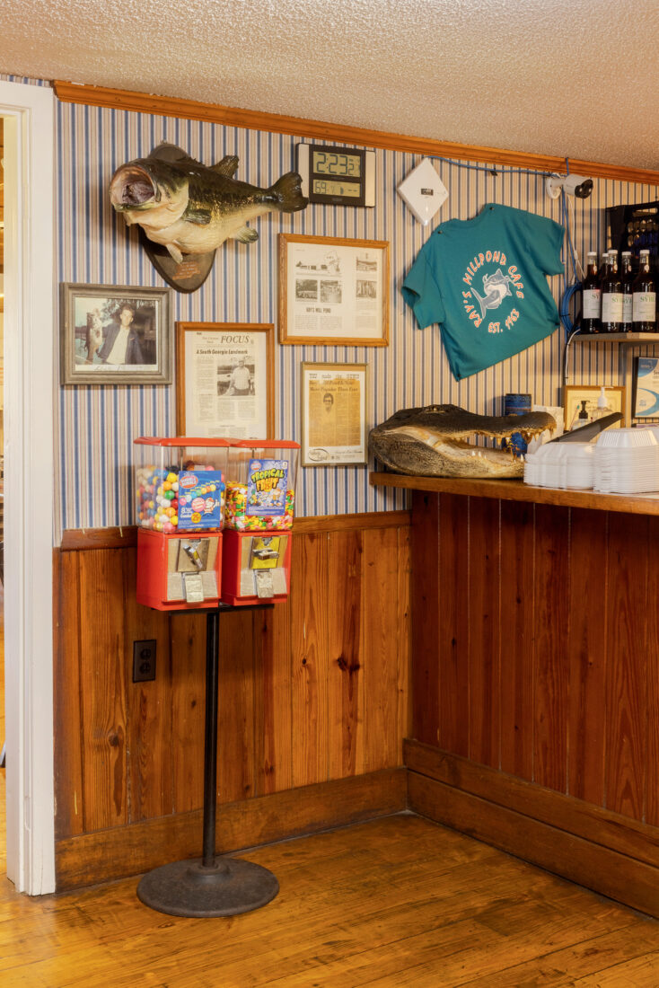 A gumball machine and knick knacks on the wall of a restaurant entrance