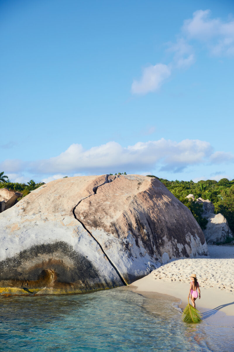 A woman walks on a beach