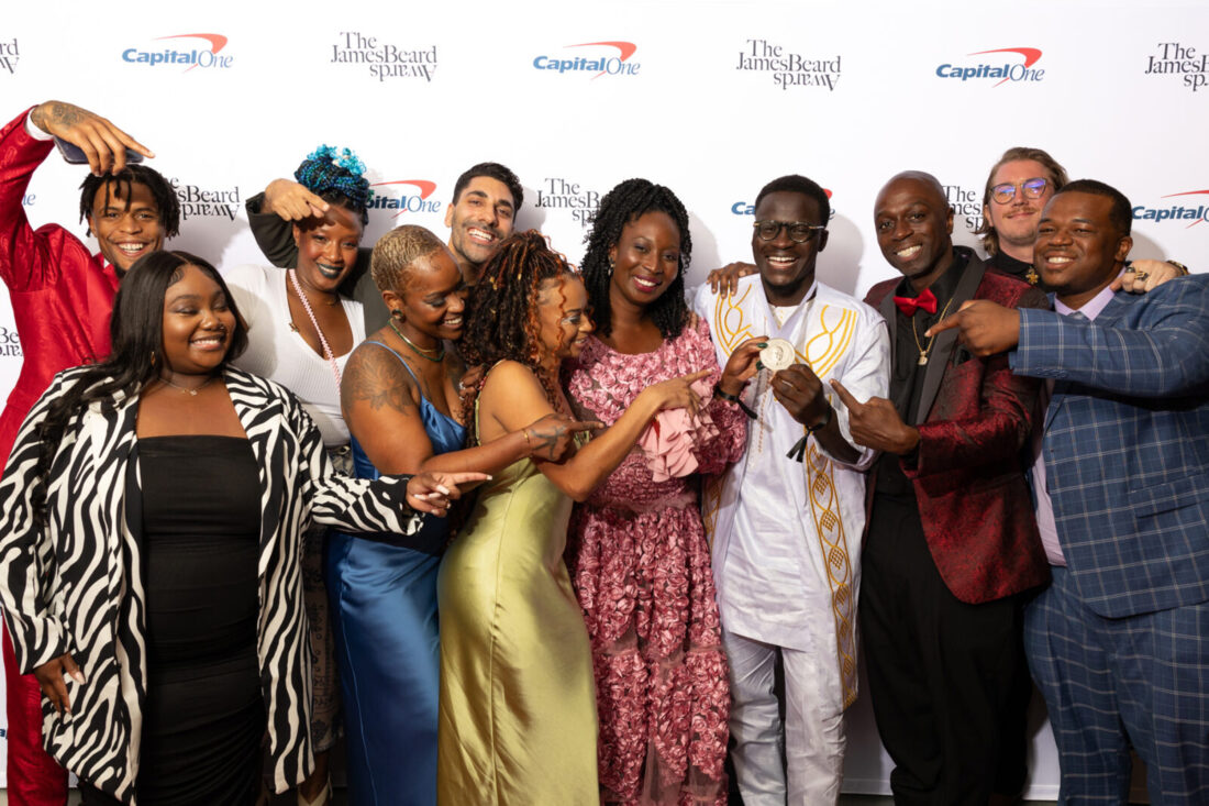 A group of people pose with a medal