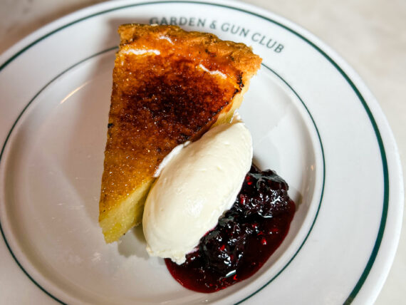 A slice of pie with berry compote