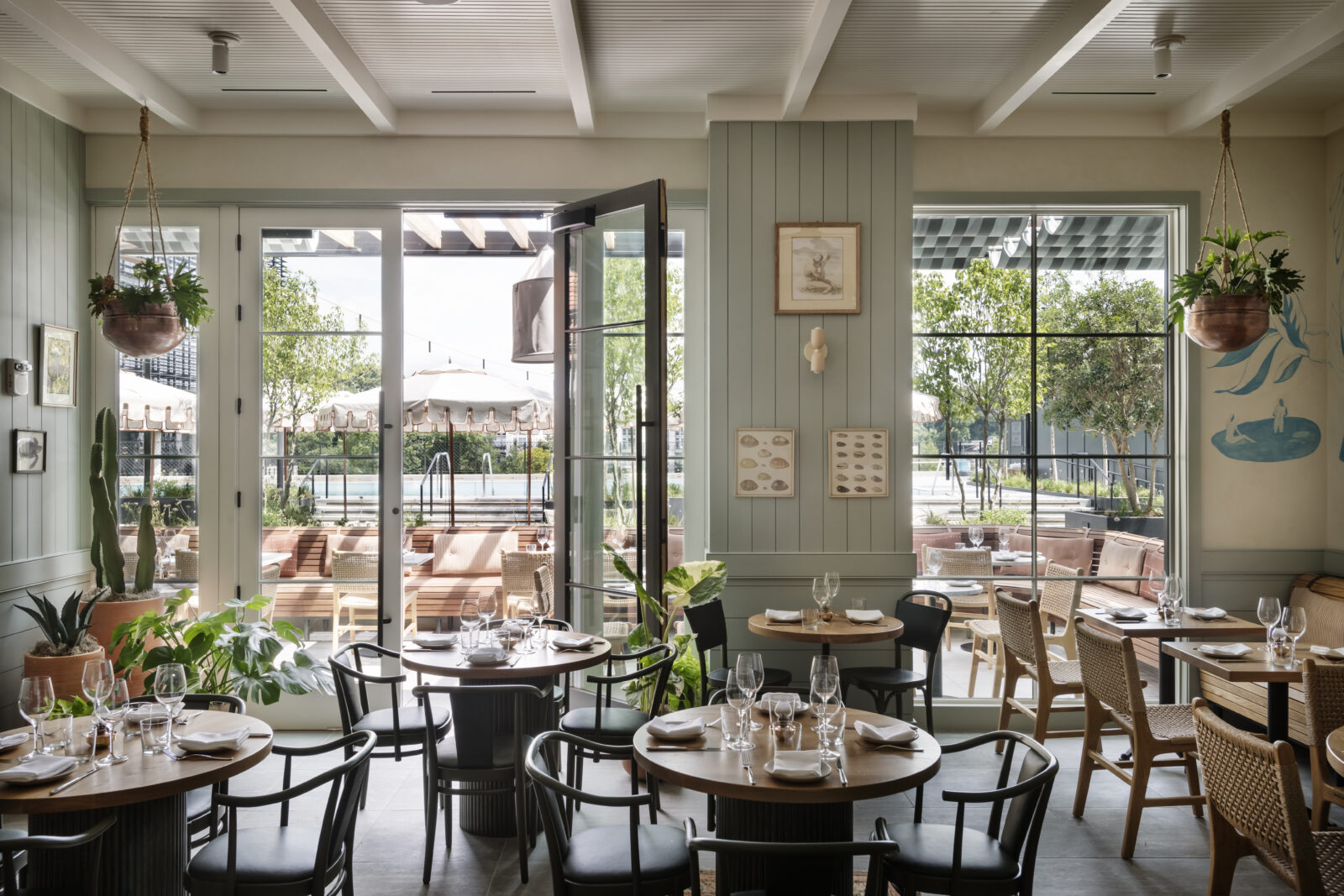 A restaurant's doors open to a poolside