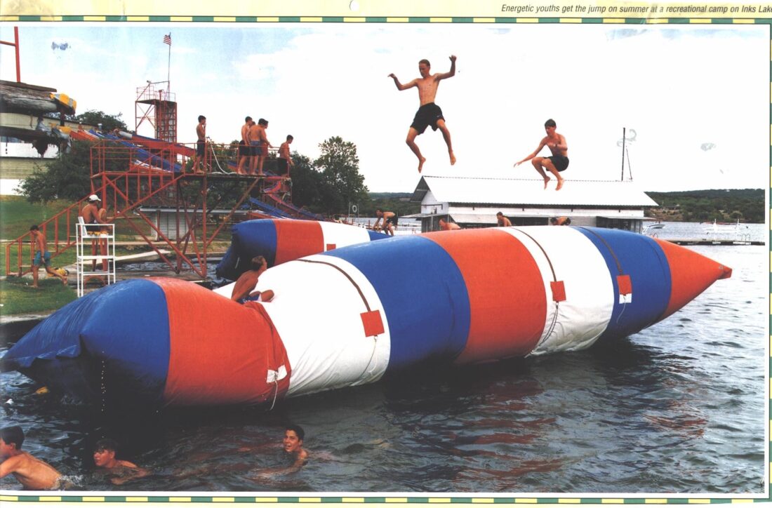 A red white and blue Blob on the water. Kids jump on it and swim around it