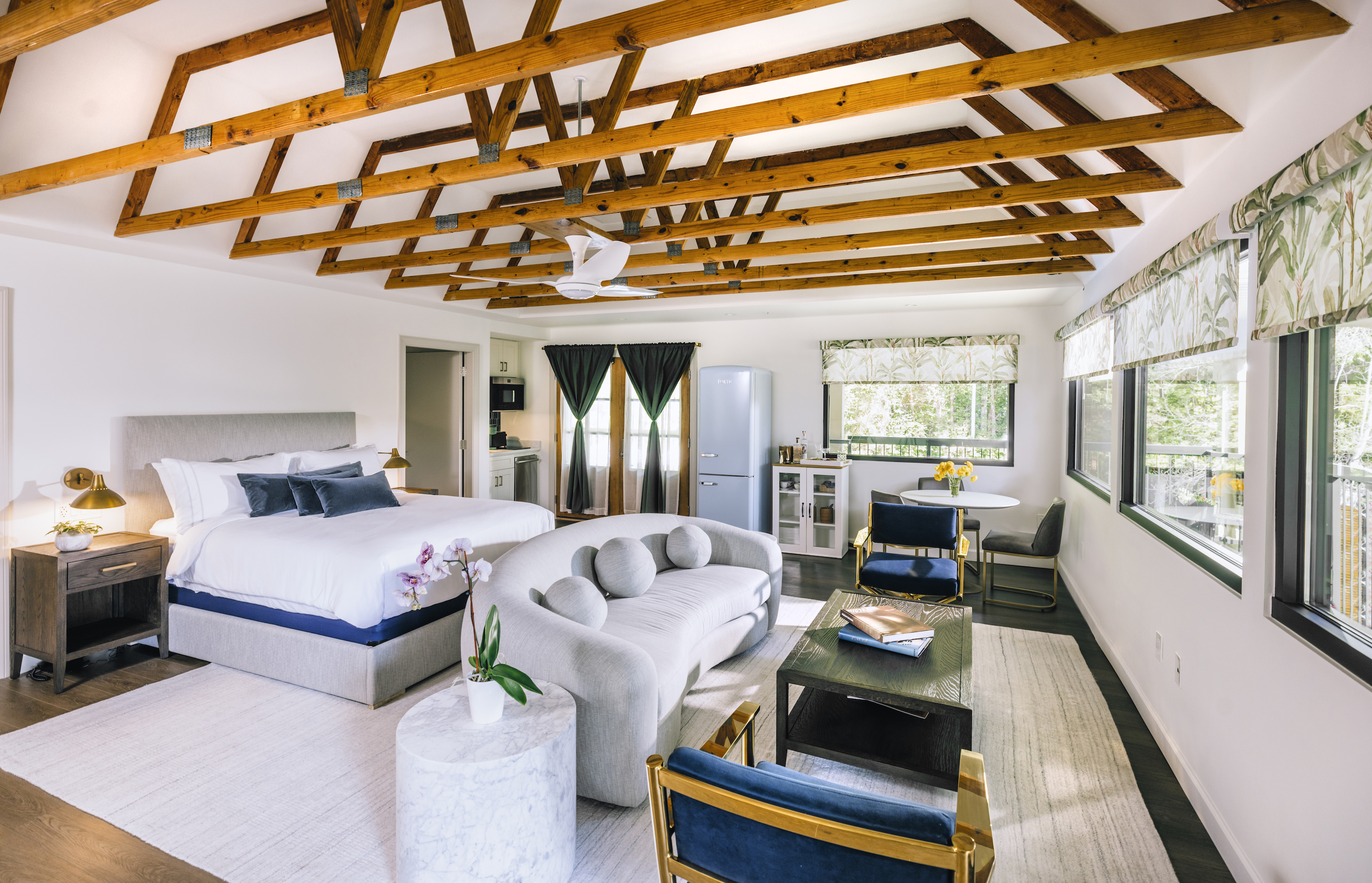 A guest room with exposed beam ceilings