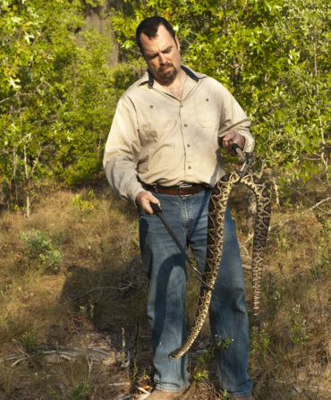 A man holding a rattlesnake.