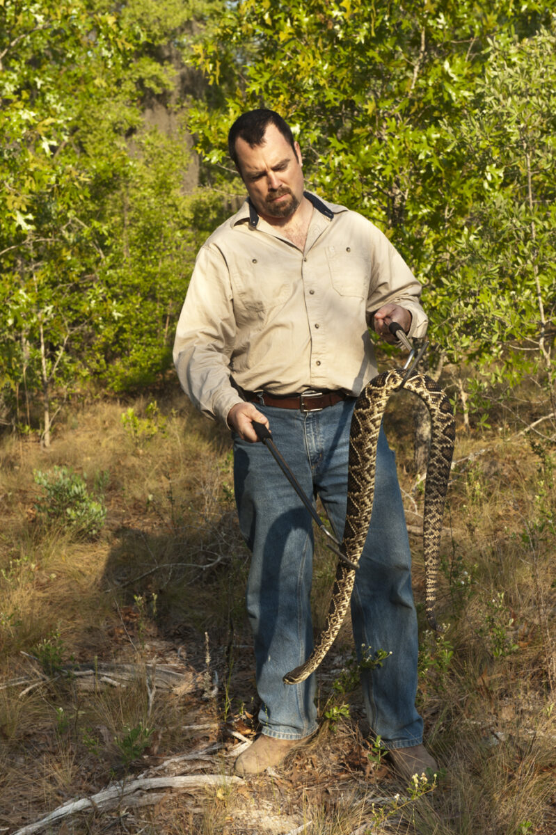 A man holding a rattlesnake.