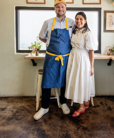 A chef couple stands in a restaurant