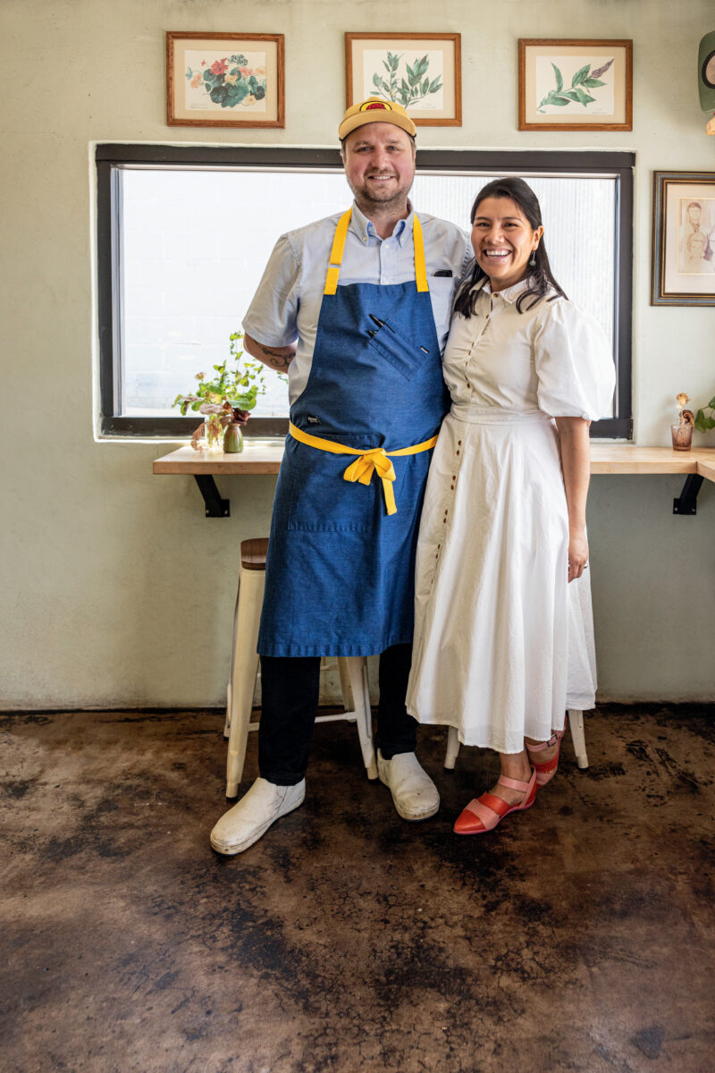 A chef couple stands in a restaurant