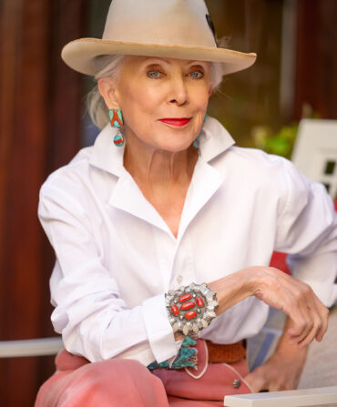 A portrait of a woman with a hat and pink pants