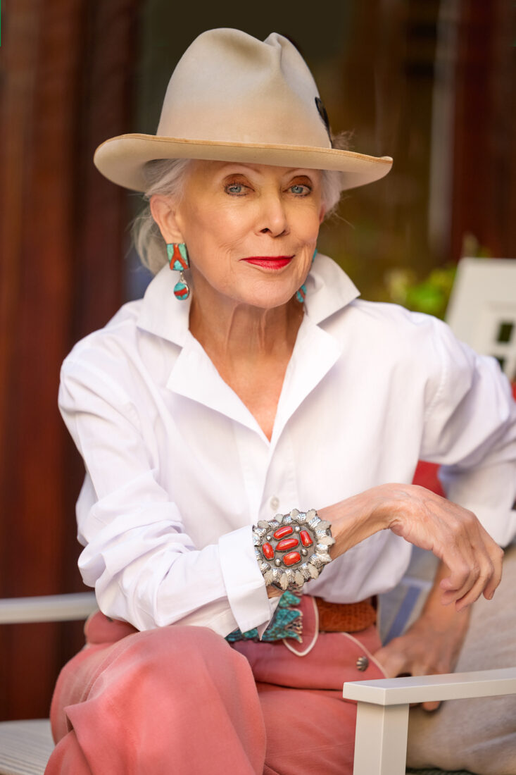 A portrait of a woman with a hat and pink pants