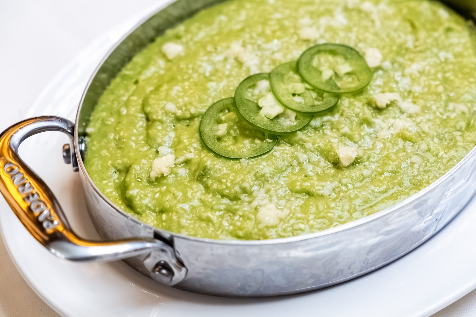 A serving dish of green grits.