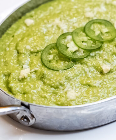 A serving dish of green grits.