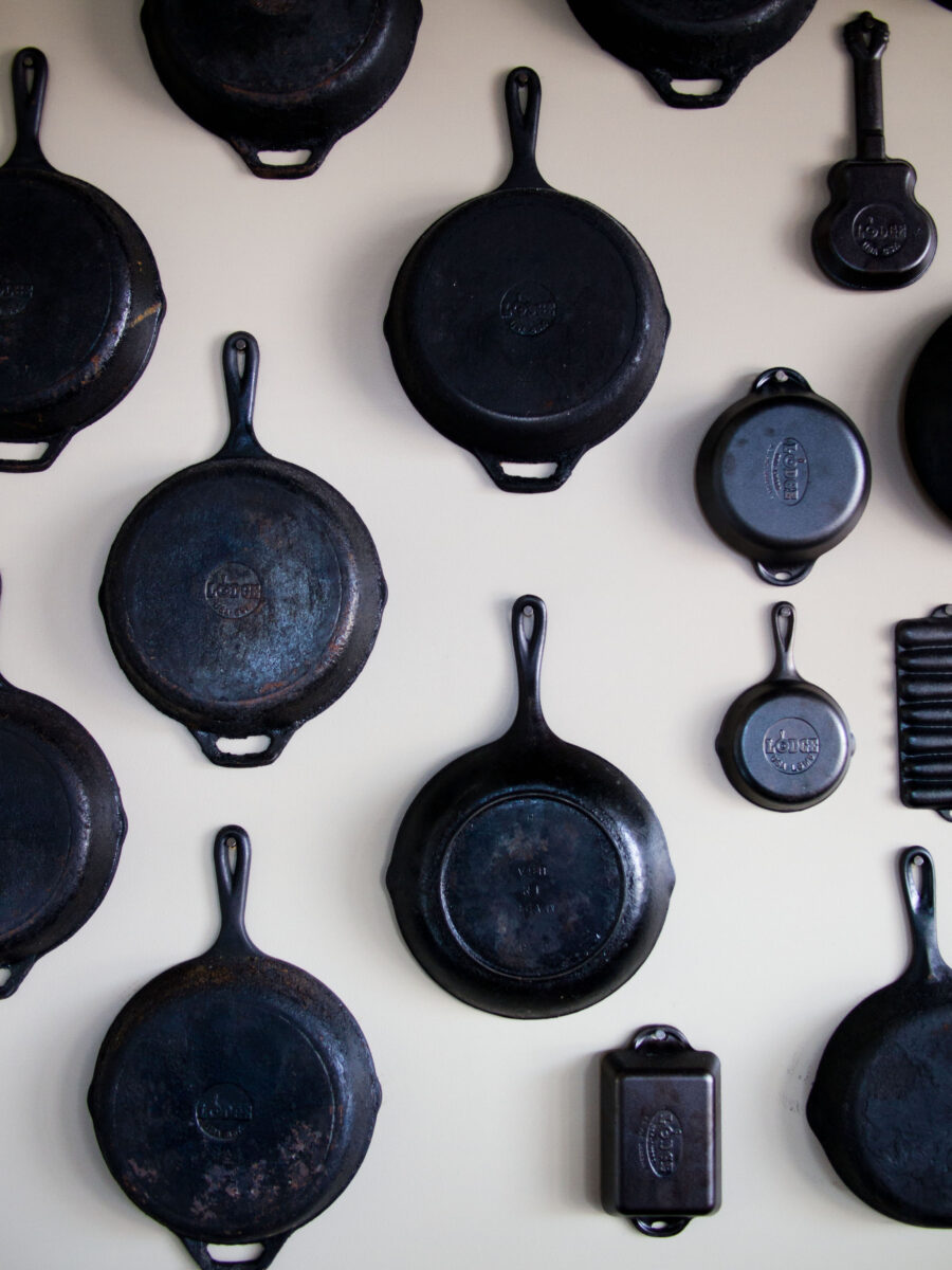 A wall of cast iron pots and pans