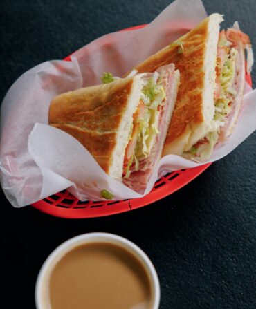 A cuban sandwich in a red basket