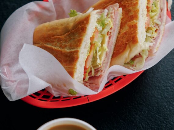 A cuban sandwich in a red basket