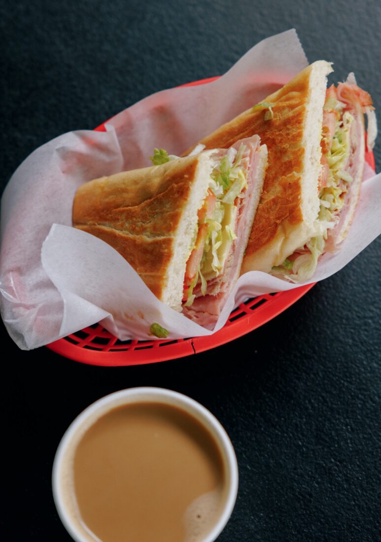 A cuban sandwich in a red basket