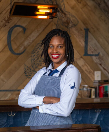 Erika Flowers stands with her arms crossed.