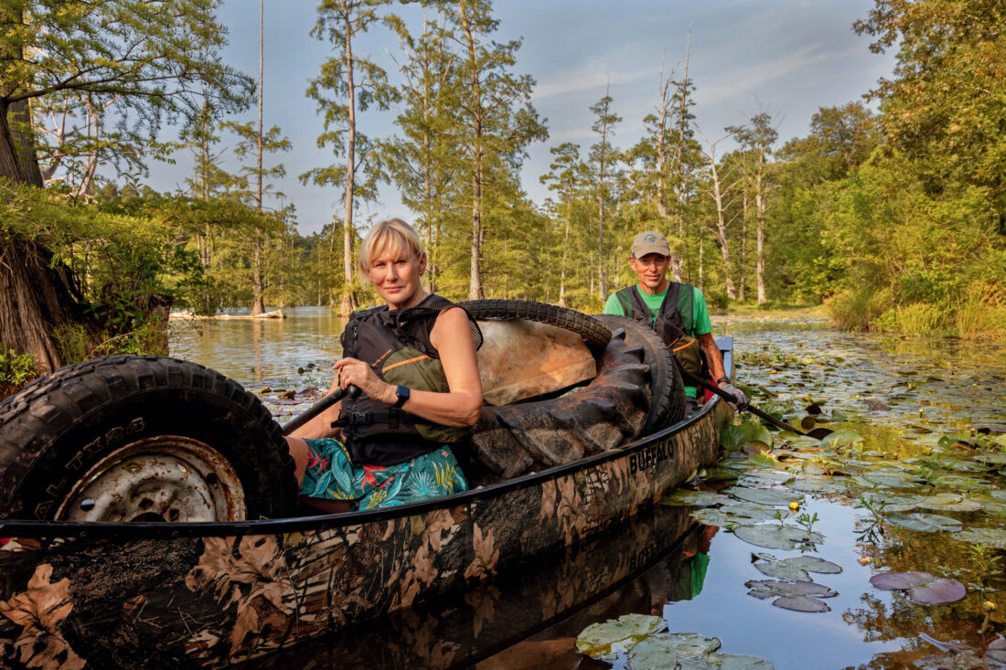 Two people sit in a canoe