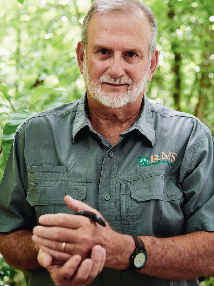 A man holds a salamander