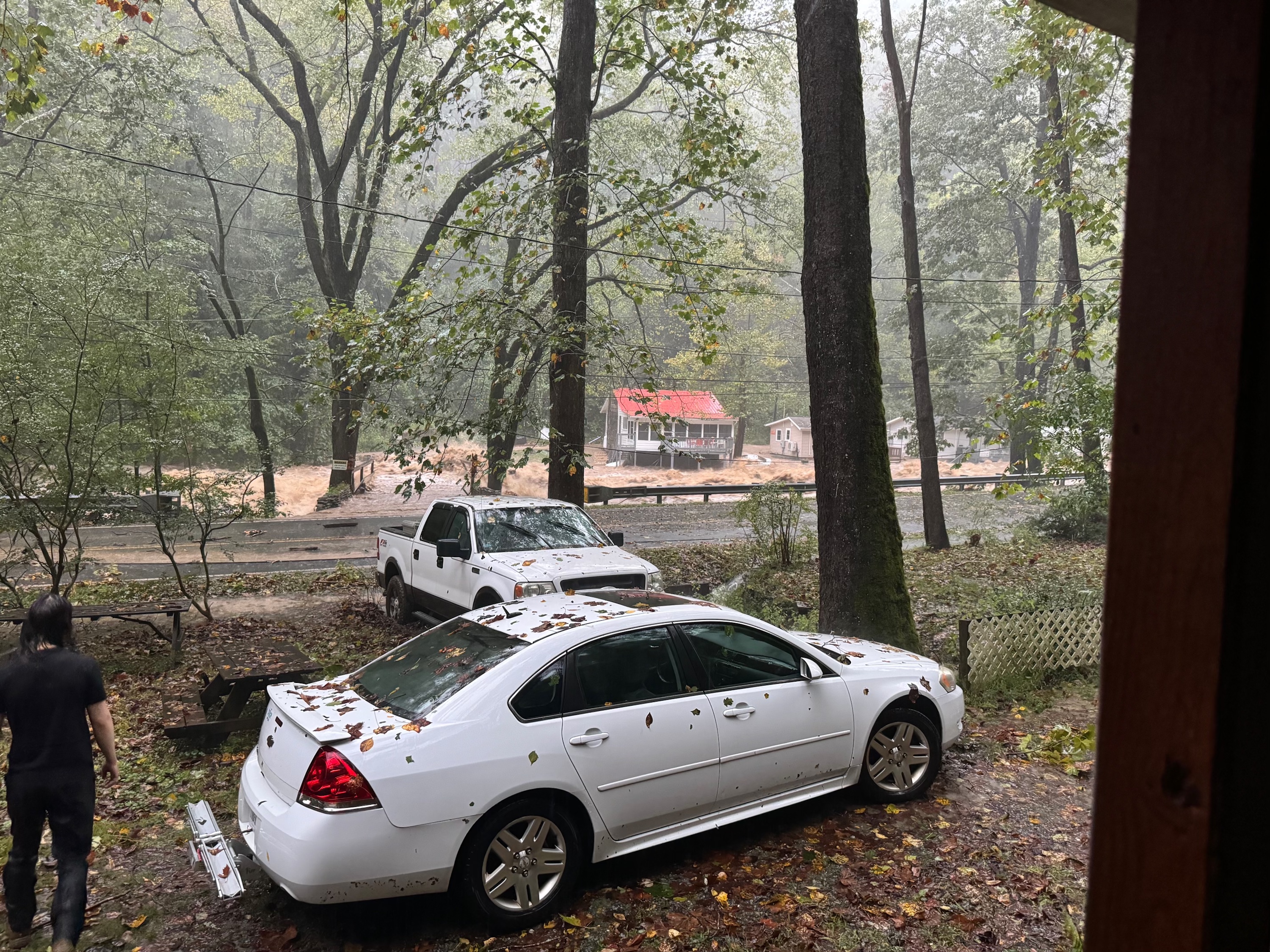 A muddy river runs through a neighborhood