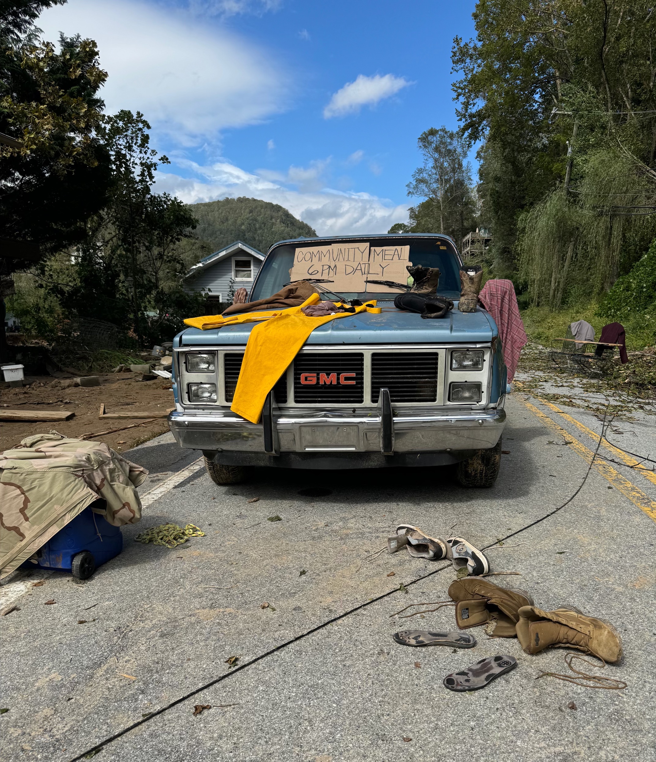 A truck has a sign offering community meals