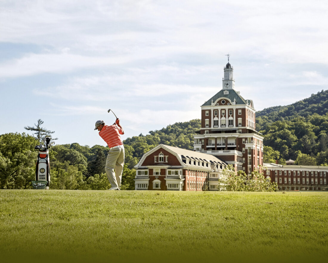 A golfer swings at The Omni Homestead Resort Old Course.