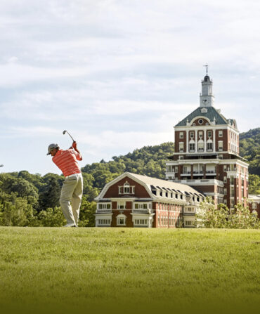 A golfer swings at The Omni Homestead Resort Old Course.