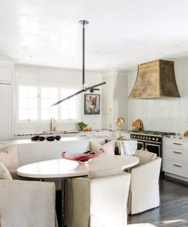 A brass hood in a white kitchen