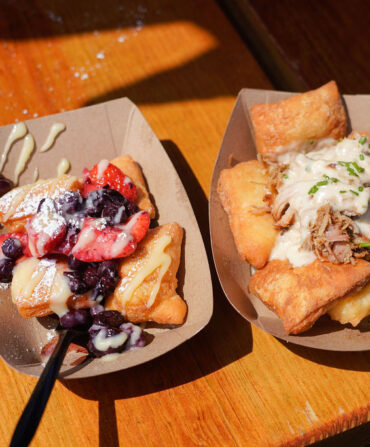 Two different servings of beignets. One on the right with fruit and the other with meat and sauce.