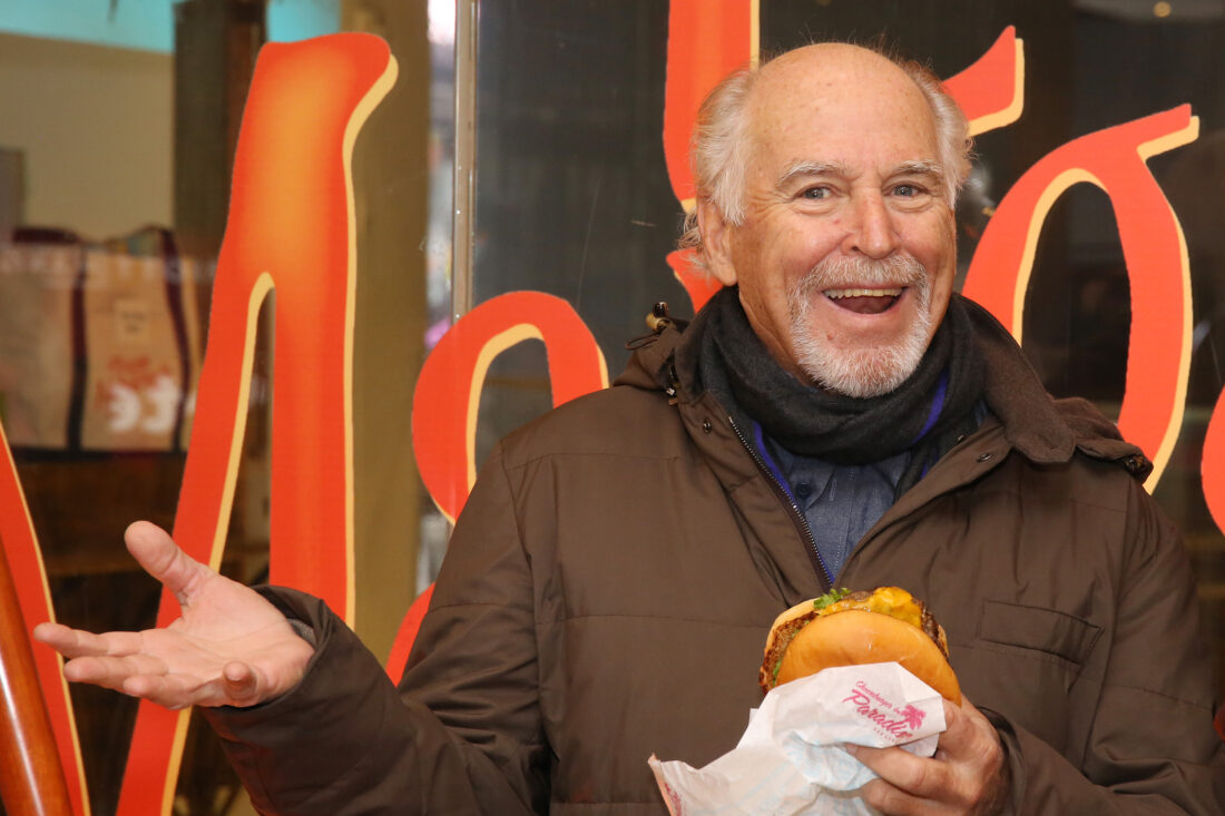 A man holding a cheeseburger