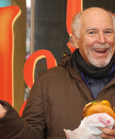 A man holding a cheeseburger