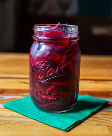 A mason jar with pickled red onions