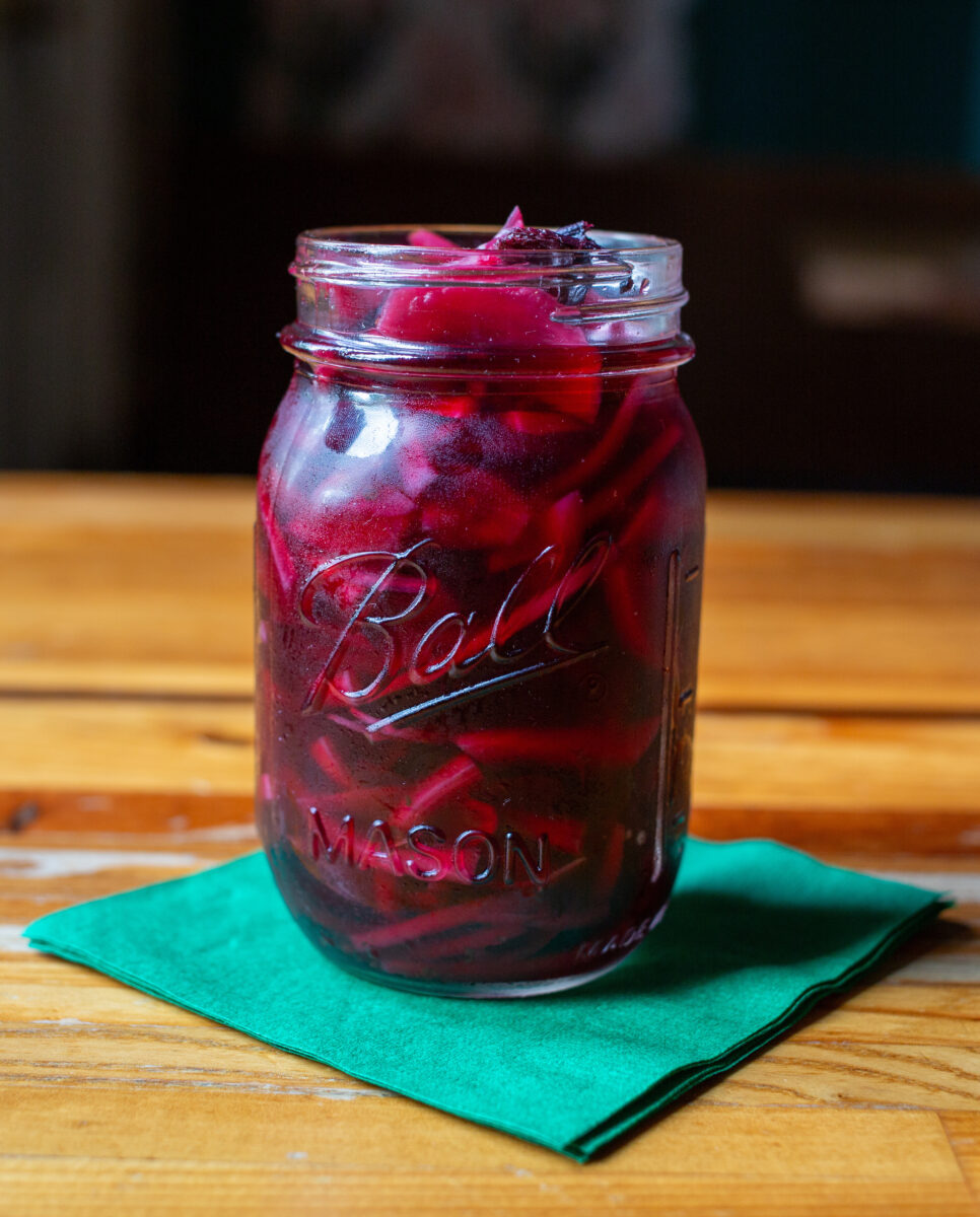 A mason jar with pickled red onions