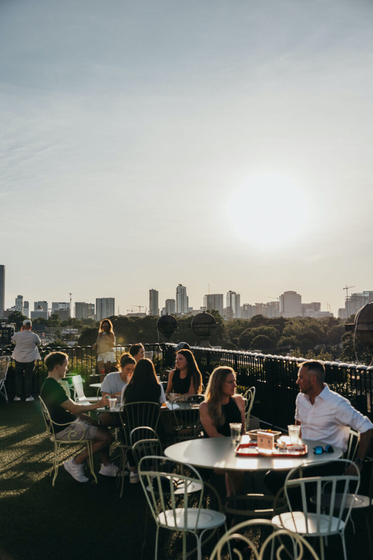 A rooftop bar with a skyline view of Atlanta