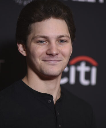 A portrait of a man against a black background