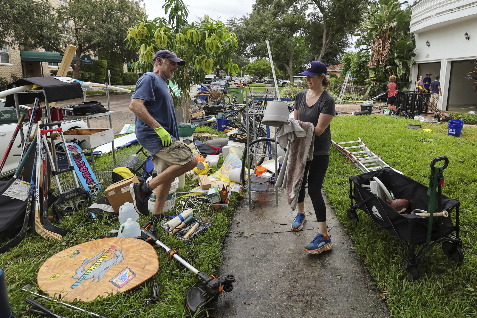 A group of people organize items that were impacted by flooding from Hurricane Helene.