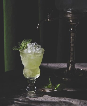 A green-colored cocktail in a glass