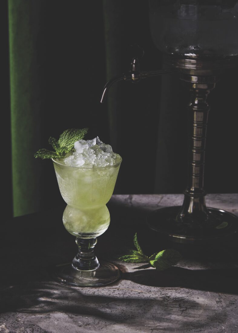 A green-colored cocktail in a glass