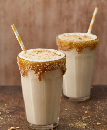 Two glasses of bourbon apple pie milkshakes.