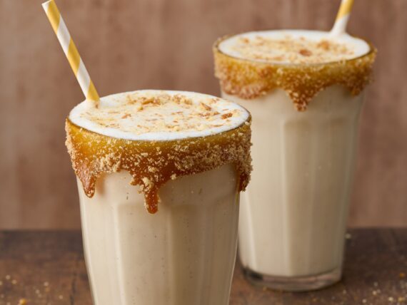 Two glasses of bourbon apple pie milkshakes.