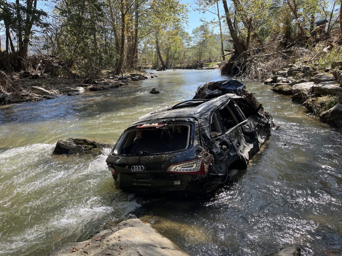 A dismantled vehicle in the river.