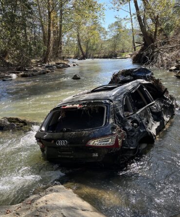 A dismantled vehicle in the river.