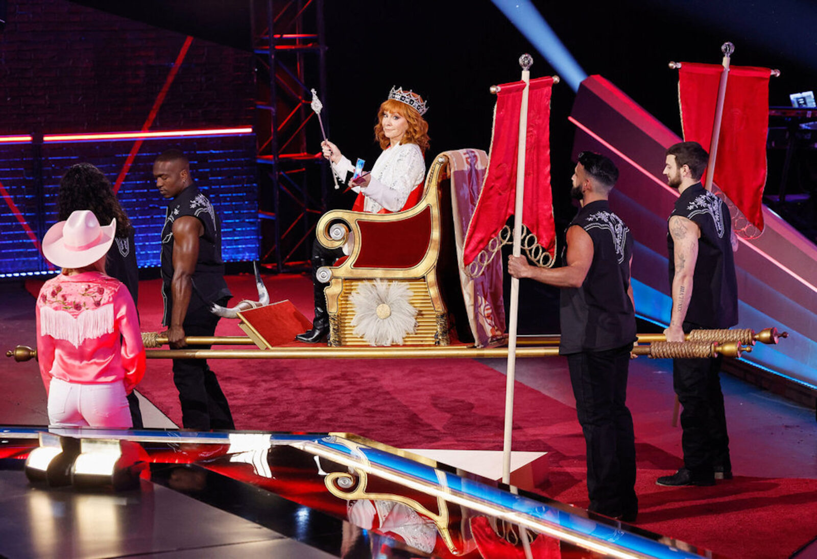 Reba McEntire being carried on a throne