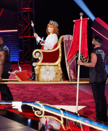 Reba McEntire being carried on a throne