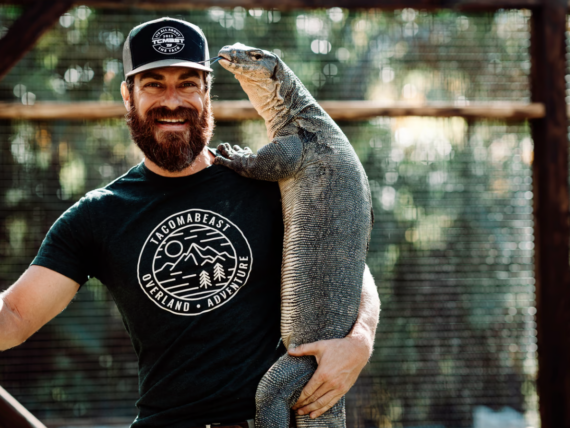 A man holds a large lizard