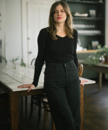 A portrait of a woman in a kitchen