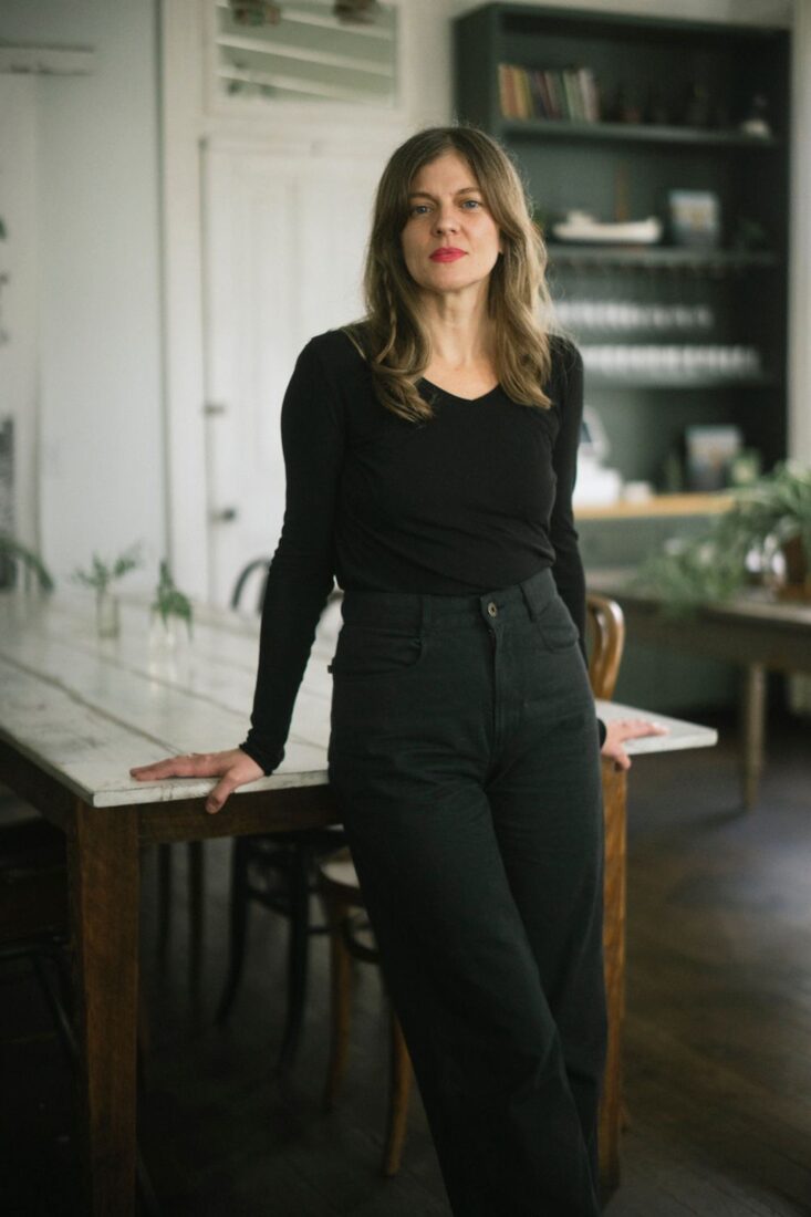 A portrait of a woman in a kitchen