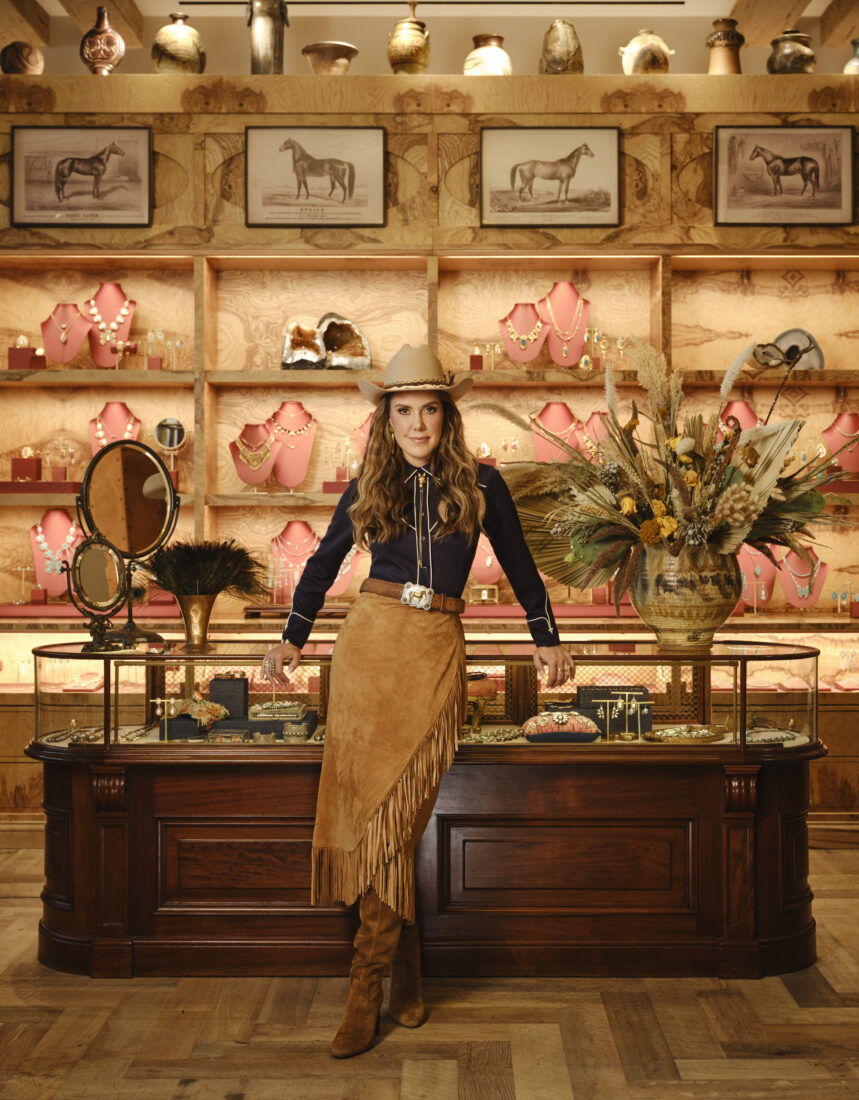 A woman in western clothes stands in a clothing store