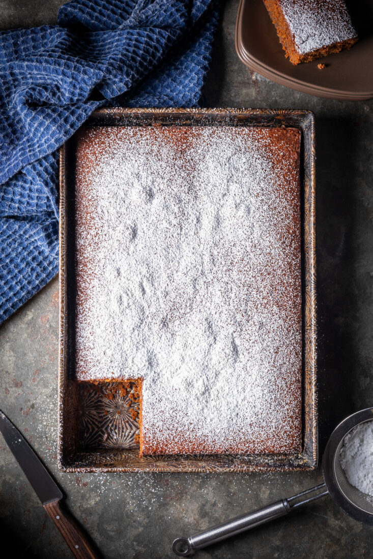 A pan of brown cake with powdered sugar on top