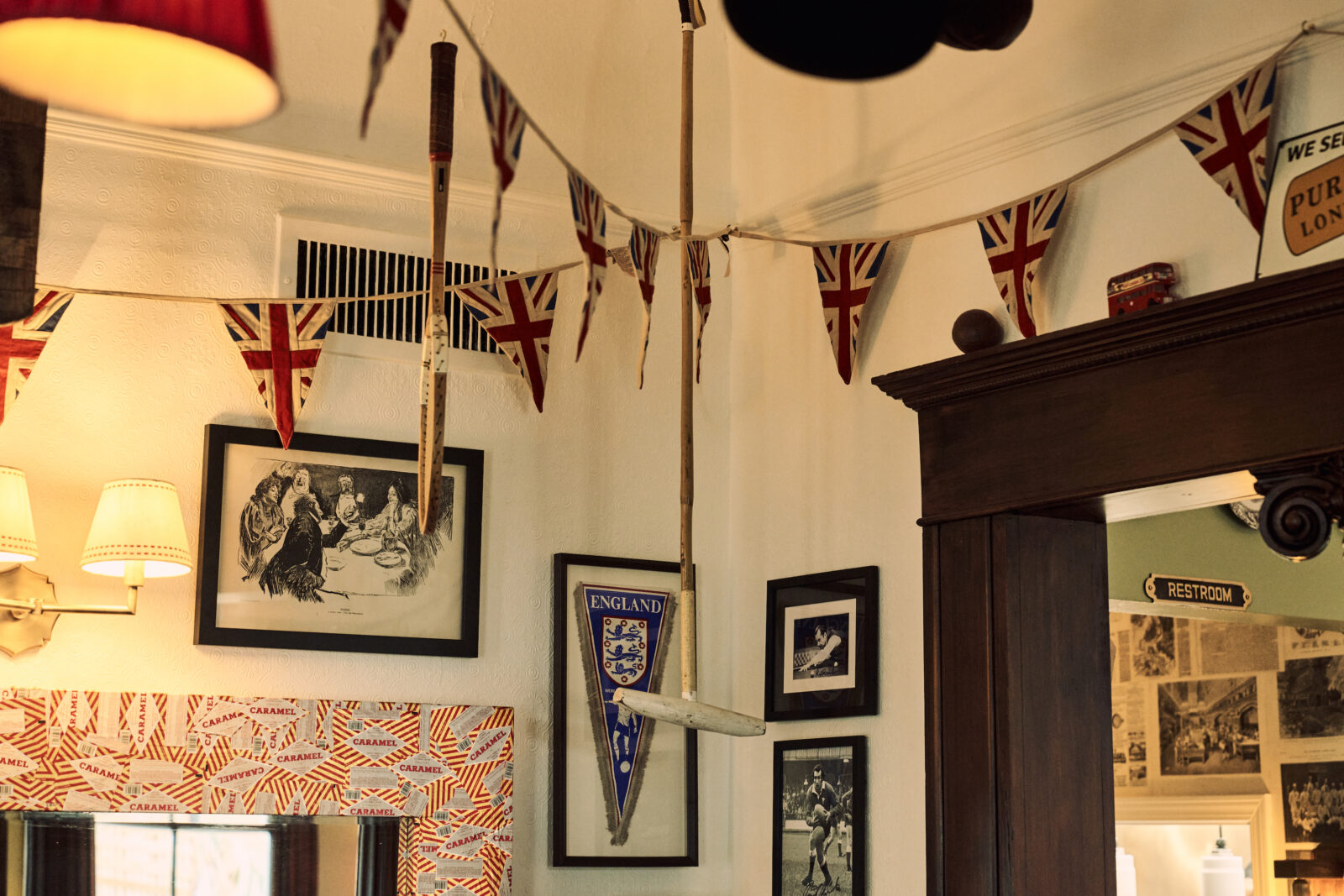 The walls and ceilings are hung with Union Jack flags, croquet mallets, wooden tennis racquets, and other knickknacks